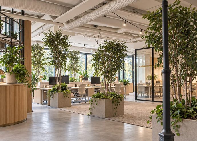 Visionsbild över kontorsmiljö med utsikt över Borås stadspark, AI-genererad